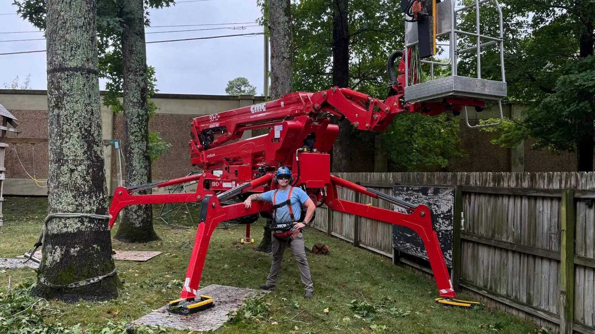 arborist standing beside a spider crane