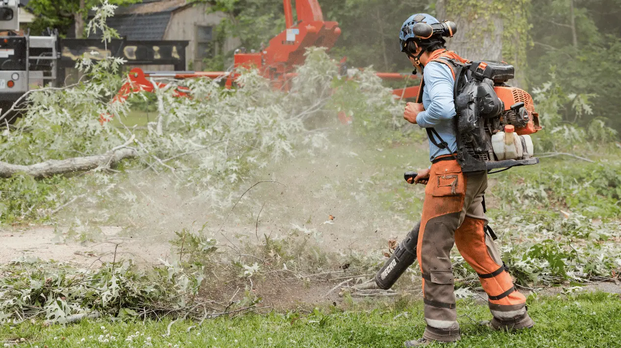 757 Tree Solutions crew member using a backpack blower during tree debris cleanup